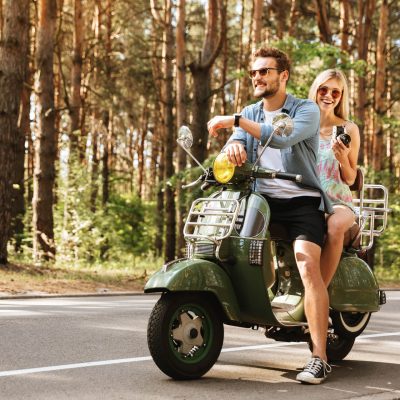 young-handsome-man-scooter-with-womanfriend-holding-camera